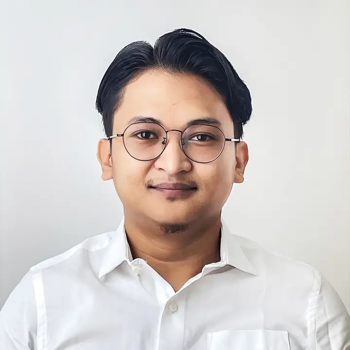 Portrait photo of a man wearing round metal-framed glasses